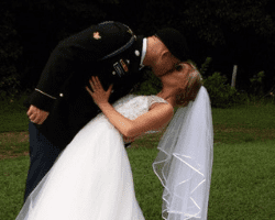 A Norman's bride and her groom share a kiss.
